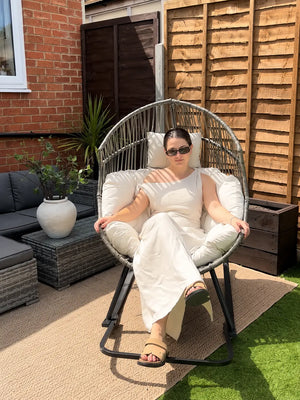 Oversized Egg Rattan Rocking Chair in a contemporary British garden with premium cushions and comfortable outdoor seating.