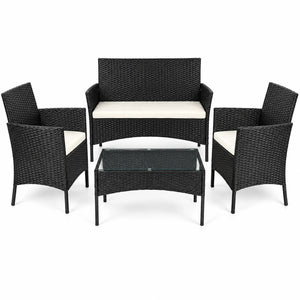 4-piece black rattan garden sofa set with two armchairs and a glass-top coffee table