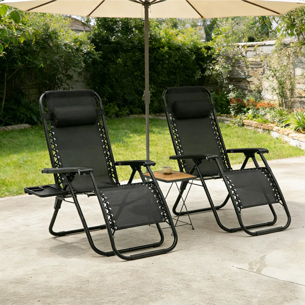 Pair of black zero-gravity reclining garden chairs under a parasol on a patio