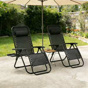 Pair of black zero-gravity reclining garden chairs under a parasol on a patio