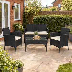 Four-seat black rattan furniture set styled in a bright garden seating area