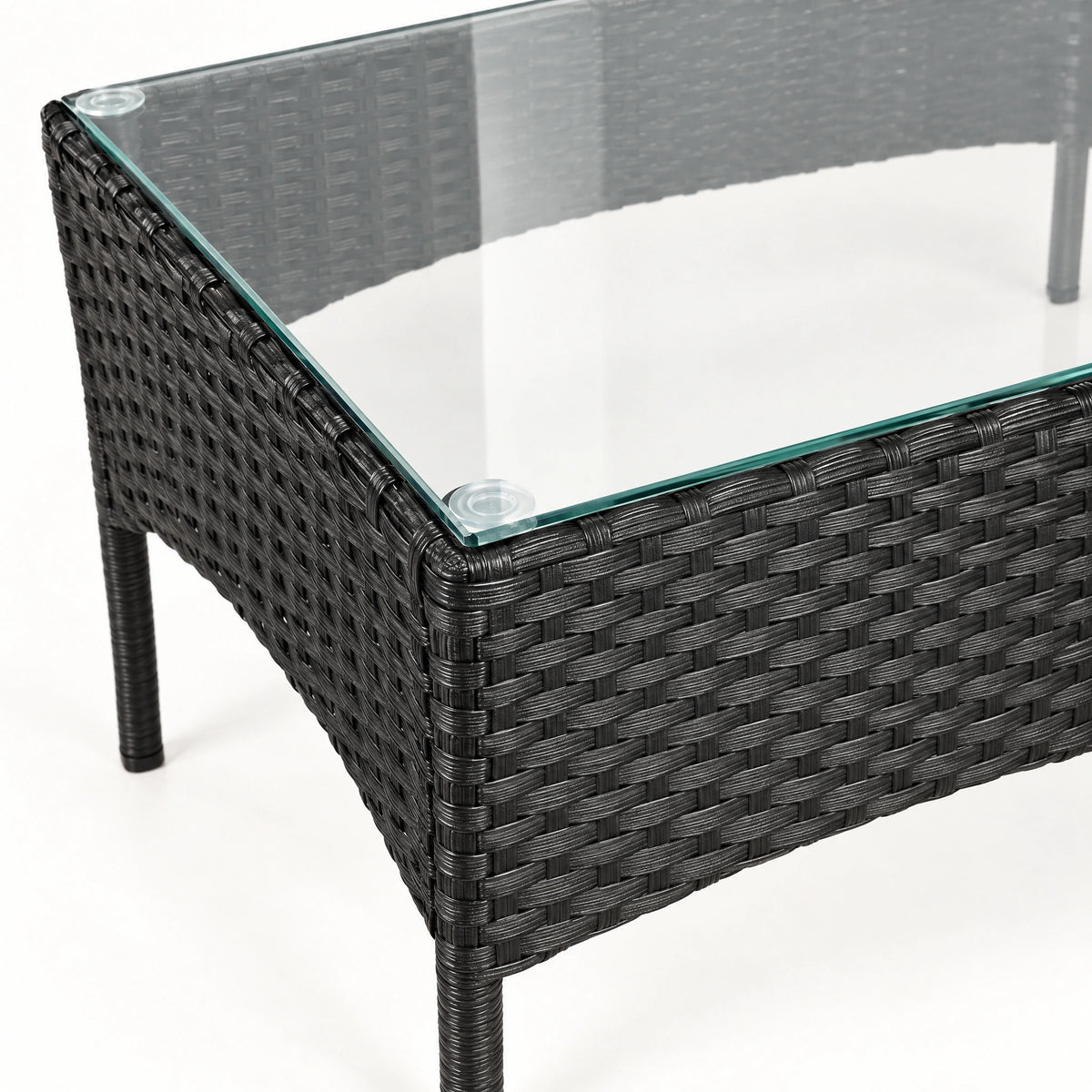 Glass-top rattan coffee table with an open frame underneath